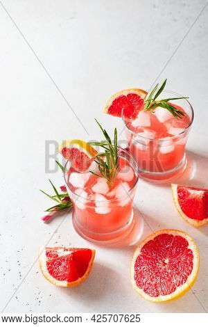 Grapefruit Summer Coctail Grink With Slice Of Grapefruit And Rosemary On White Background, Copy Spac