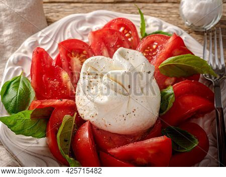 Burrata Salad On White Vintage Plate. Top View Of Salad With Burrata Cheese And Basil Leaves.