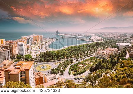 Malaga, Spain. Cityscape Elevated View Of Malaga In Sunny Summer Evening. Altered Sunset Sky.