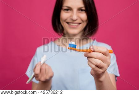 Beautiful Happy Young Woman With Toothbrush On Blank Pink Background