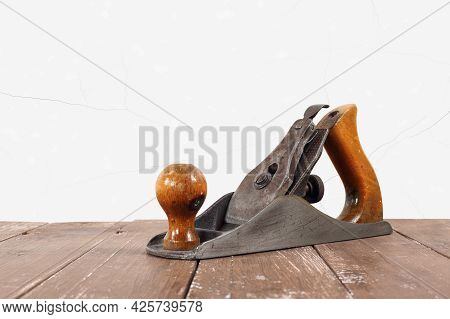 Tools Building And Repair - Old Rusty Metal Hand Plane Closeup A White Wall Background.