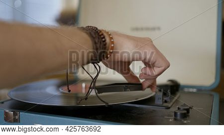 Close-up Of Hand Putting Record In Vinyl Player. Action. Man Puts Vintage Record In Modern Stylish R