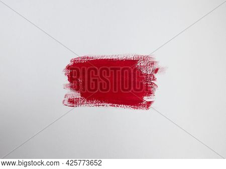 Crimson Red Paint Patch On Plain White Background With Copy Space