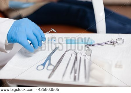 Close Up Stomatolog Taking Ustensils For Dental Intervention Of Senior Woman. Elderly Patient During