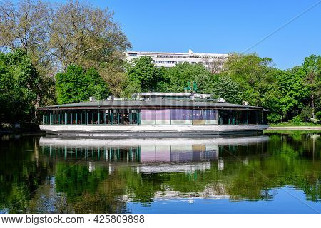 Vivid Green Landscape With Old Large Linden Trees And Green Leaves Near The Lake In Cismigiu Garden 