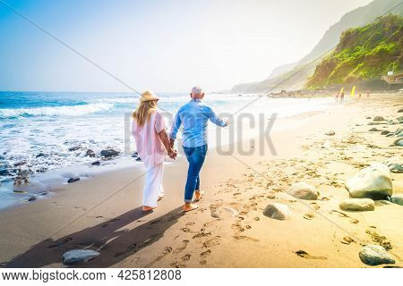 Lifestyle With Caucasian Senior Couple Walking On Beach, Happy In Love Romantic And Relax Time, Tour