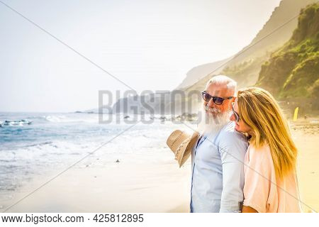 Lifestyle Of Caucasian Senior Couple Huggung On Beach, Happy In Love Romantic And Relax Time, Touris