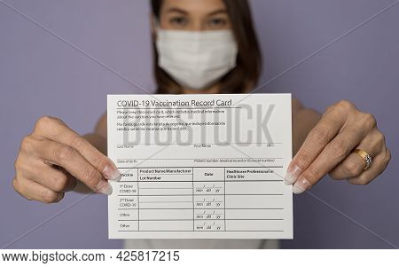 Selective Focus On Paper, Vaccinated Woman Wearing Medical Mask Holding Showing Covid-19 Coronavirus