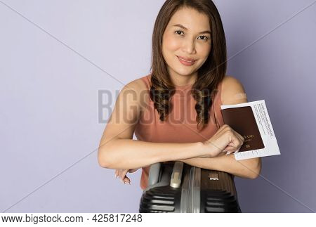 Selective Focus On Passport, Vaccinated Asian Woman Holding Travel Bag And Showing Vaccine Injection