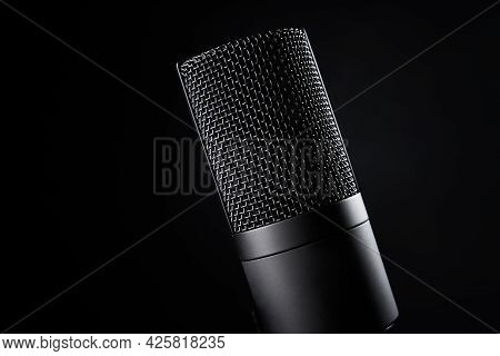 Studio Microphone On Dark Background With Copy Space. Black Professional Condencer Microphone. Podca