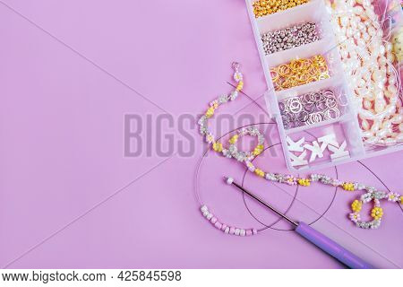Creative Flatlay Of Different Pearl Beads With Tools For Making Jewelry, Wire String And Necklace Is