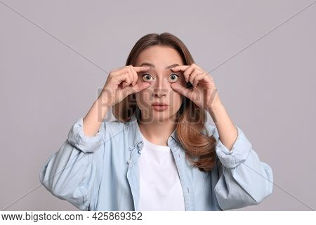 Woman With Yellow Eyes On Grey Background. Liver Problems Symptom