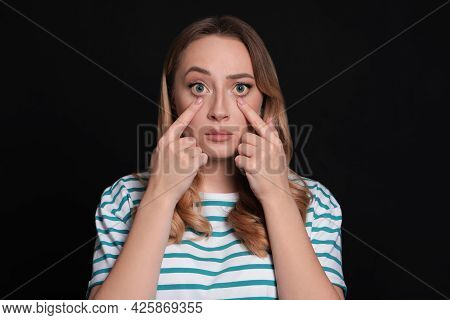 Woman With Yellow Eyes On Black Background. Liver Problems Symptom