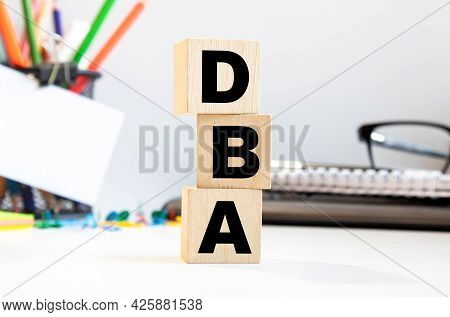 Dba - Acronym From Wooden Blocks With Letters, Database Administrator Or Doing Business As Abbreviat
