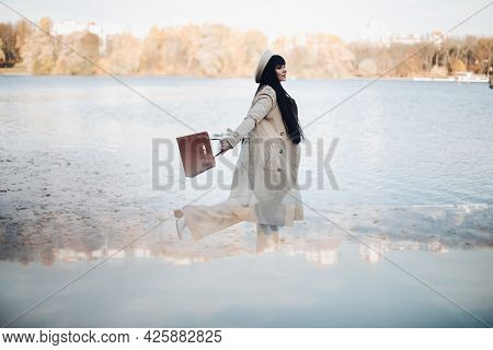 Picture Of Attractive Woman Goes For A Walk Near The River, Rejoices And Enjoys Of Her Llife