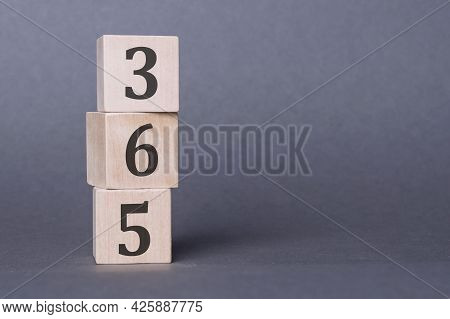 365 - Text, Written On Wooden Blocks, On Gray Background. 365 New Days.