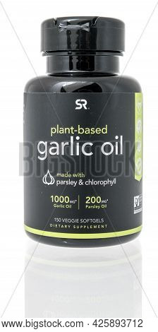 Winneconne, Wi - 13 June 2021:  A Bottle Of Sports Research Plant Based Garlic Oil Supplement On An 
