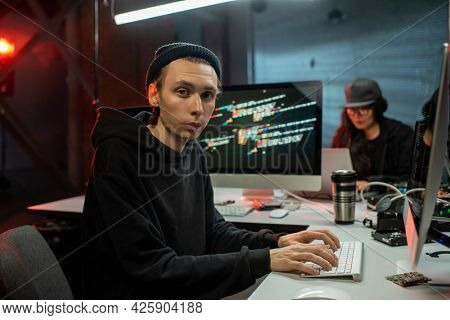 Male programmer applying anti-terror software in computer