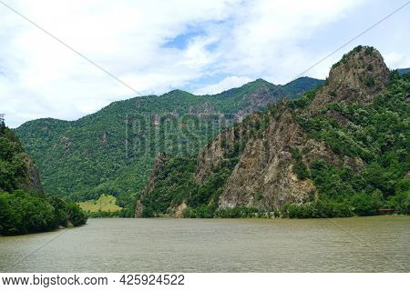 Landscape of Olt Valley with Olt river and Cozia Mountains in Romania                               