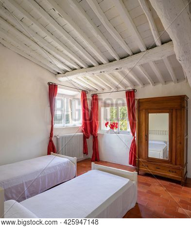 interior of an old bedroom with two single beds. Nobody inside