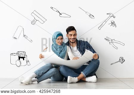 Smiling Middle-eastern Family Planning New House Repairing