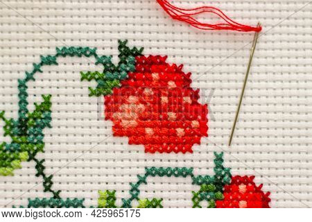 Red Ripe Strawberries Embroidered With A Cross-stich On A White Canvas By Hand. With A Needle And Re