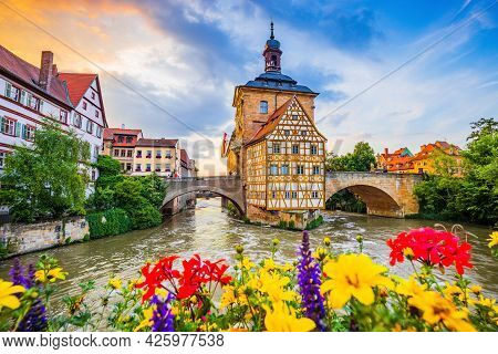 Bamberg, Germany. Town Hall Of Bamberg (altes Rathaus) With Two Bridges Over The Regnitz River. Uppe