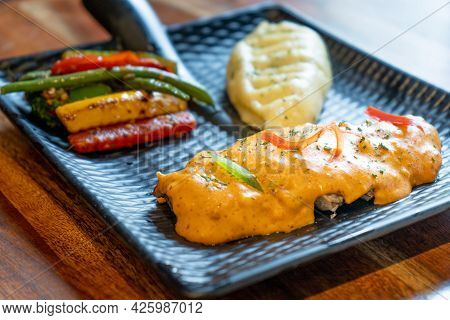 Three Quaters Shot Of Asthetic Modern Plate In Black Covered With Snack Of Mashed Potatoes Chili Sal