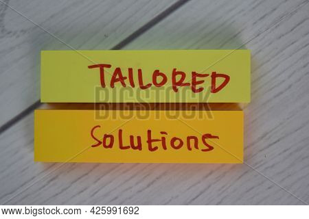 Tailored Solutions Write On Sticky Notes Isolated On Wooden Table.