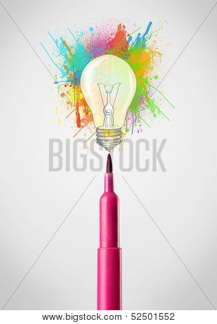 Colored felt pen close-up with colored paint splashes and lightbulb concept