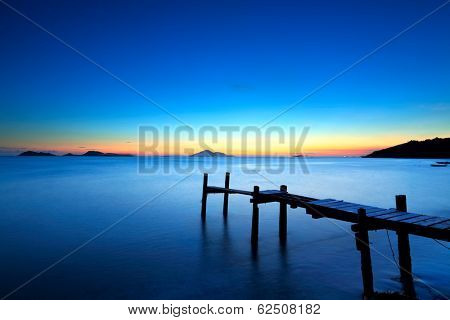 Wooden jetty with seascape during sunet