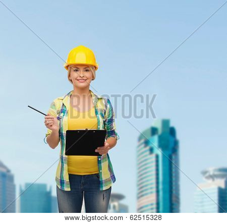 repair, construction and maintenance concept - smiling woman in helmet with clipboard