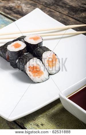 Makisushi On White Plate. Seafood Traditional Maki Sushi Rolls With Chopsticks