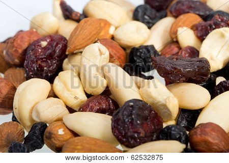 mixed nuts and dried fruits isolated on white background
