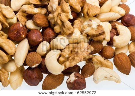 mixed nuts - hazelnuts walnuts cashews pine nuts isolated on white background
