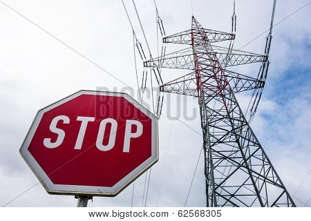 the mast of a high voltage transmission line for electricity before dark clouds.