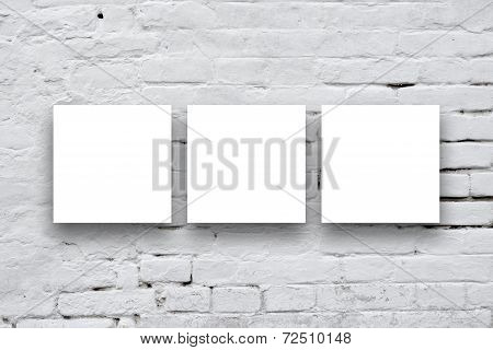 Three Square Posters Hanging On The Art Gallery Wall