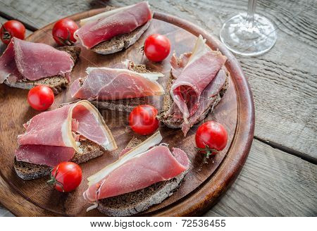 Sandwiches With Italian Ham On The Wooden Board