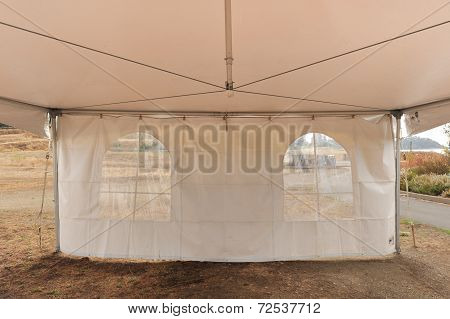 White Tents In A Dry Field Outdoors