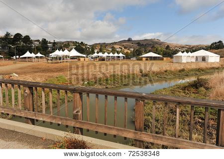 White Tents In A Dry Field Outdoors