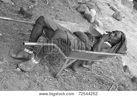 young Masai man sleep in a wheelbarrow