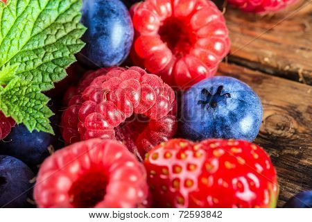 Berry fruits on wooden background