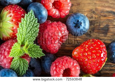 Berry fruits on wooden background