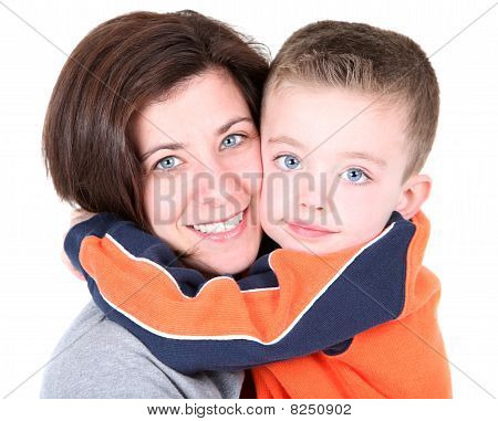 Pretty mom embracing son on white