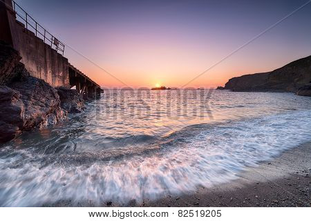 Sunset At Polpeor Cove In Cornwall