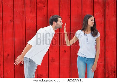 Brunette uninterested in mans advances against red wooden planks