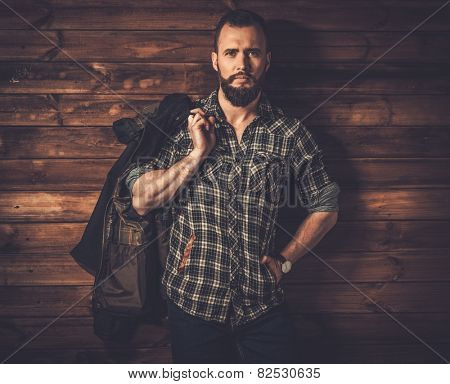 Handsome man wearing checkered  shirt and waxed canvas jacket 