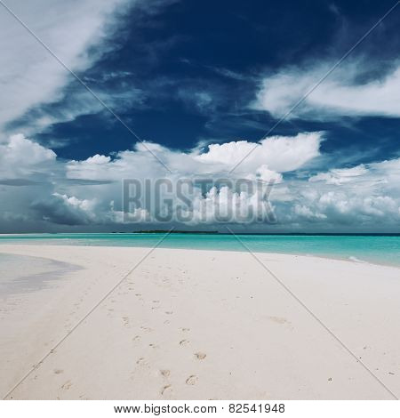 Beautiful island beach with sandspit at Maldives