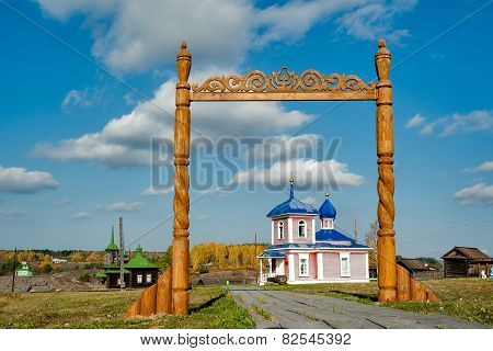 Wooden gate and Rise chapel. Russia