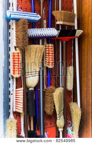 cabinet with different types of brooms